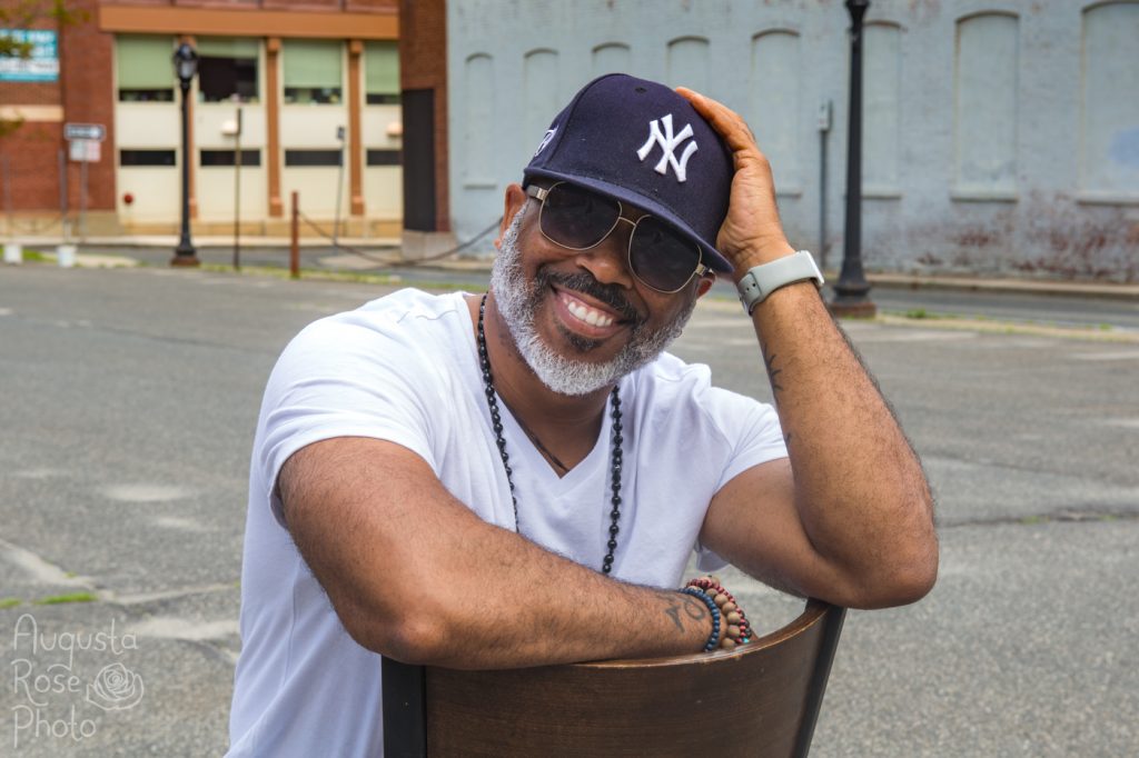 Ty Allan Jackson smiling wearing a New York Yankees hat